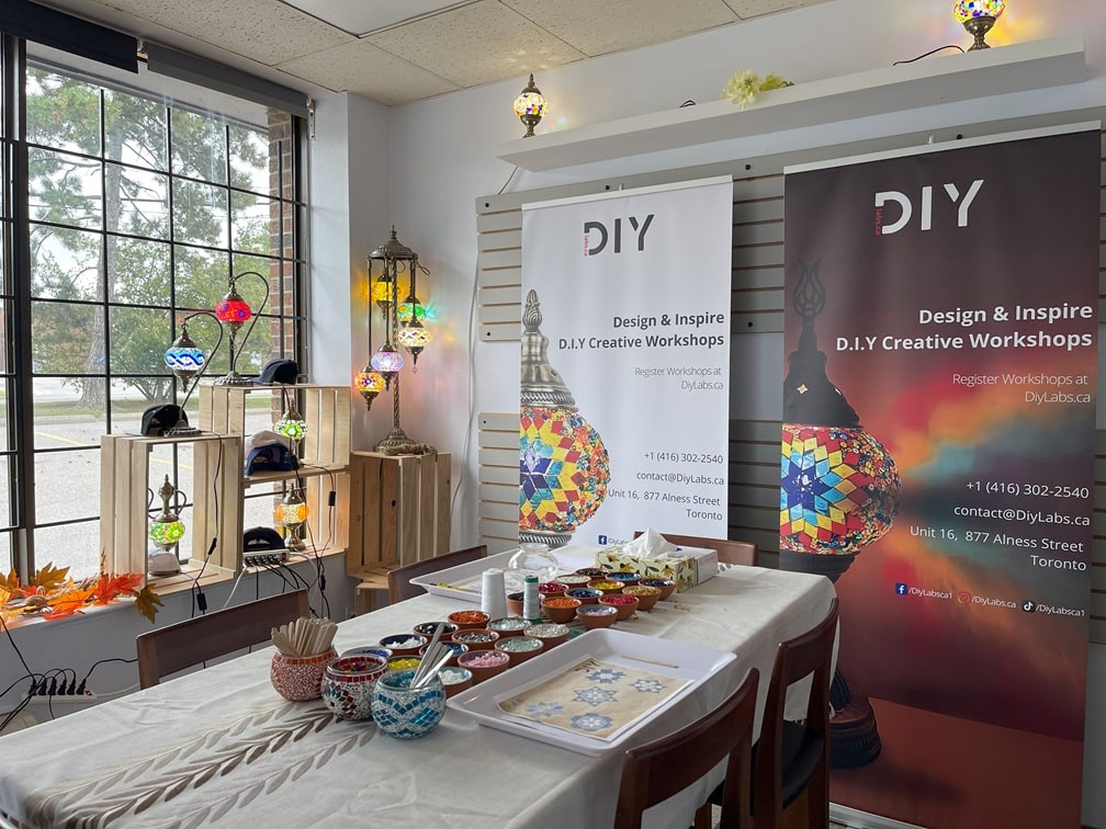 D.I.Y. Creative Workshops setup with tables, chairs, and promotional banners.